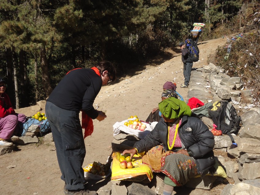 Nepalese women selling apples half way up the climb to Namche Bazaar