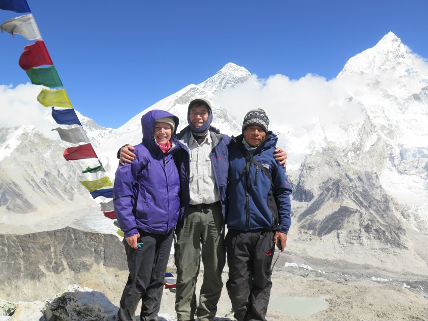 Posing in front of Everest from the top of Kala Pattar.